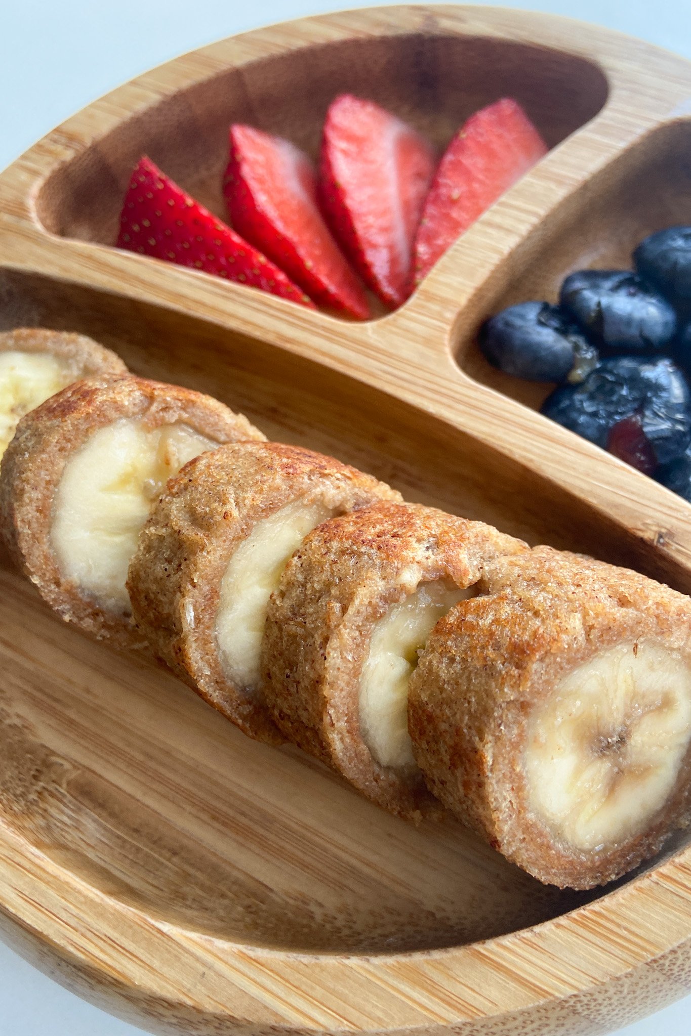 Peanut butter and banana French toast roll ups. Served with sliced strawberries and blueberries.