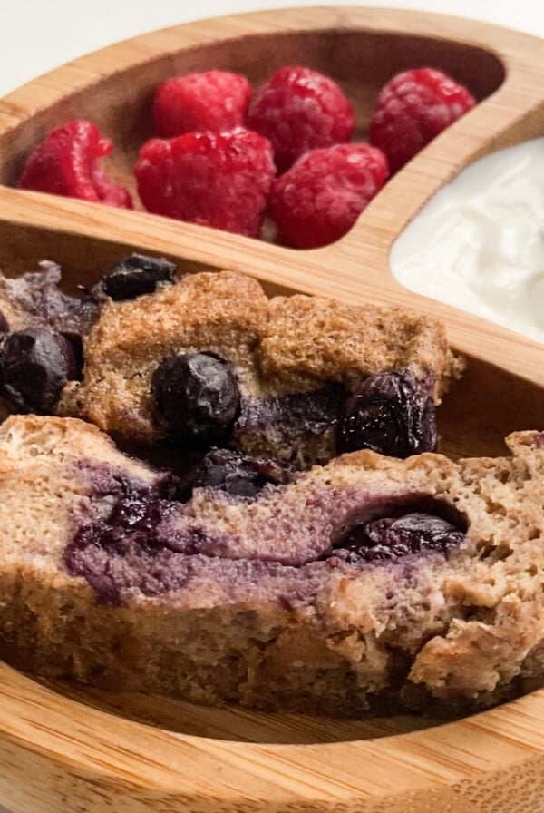 Blueberry French toast bake served with a side of yogurt and raspberries
