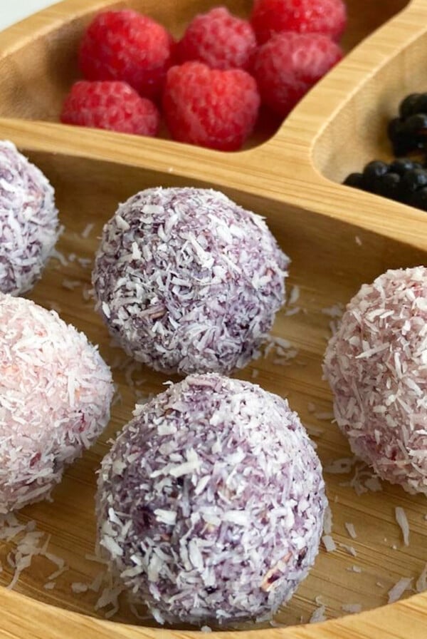 Berry bliss balls served with raspberries and blackberries