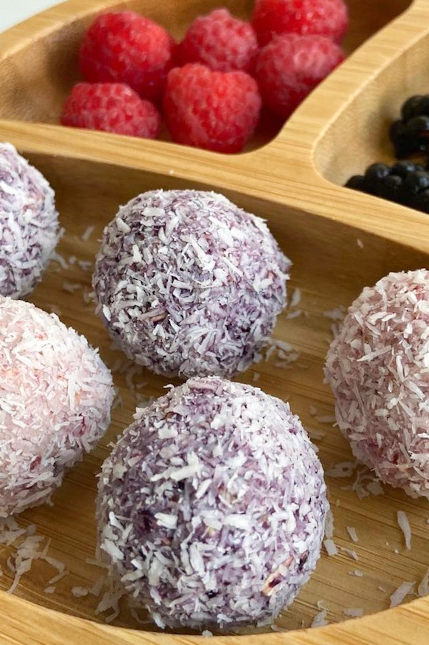 Berry bliss balls served with raspberries and blackberries