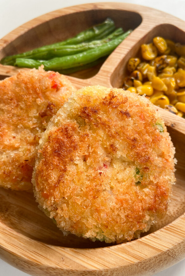 Salmon cakes served with green beans and corn