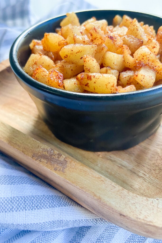 Cinnamon apples served in a black bowl