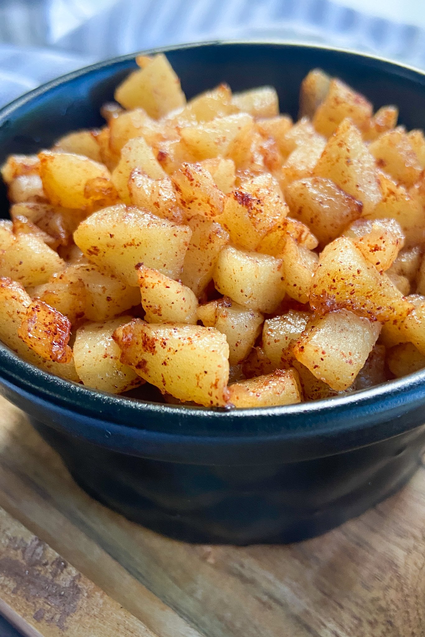 Cinnamon apples served in a black bowl