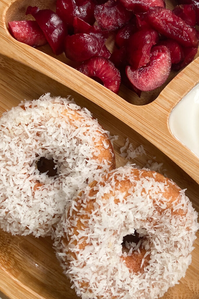 Coconut donuts served with cherries and yogurt