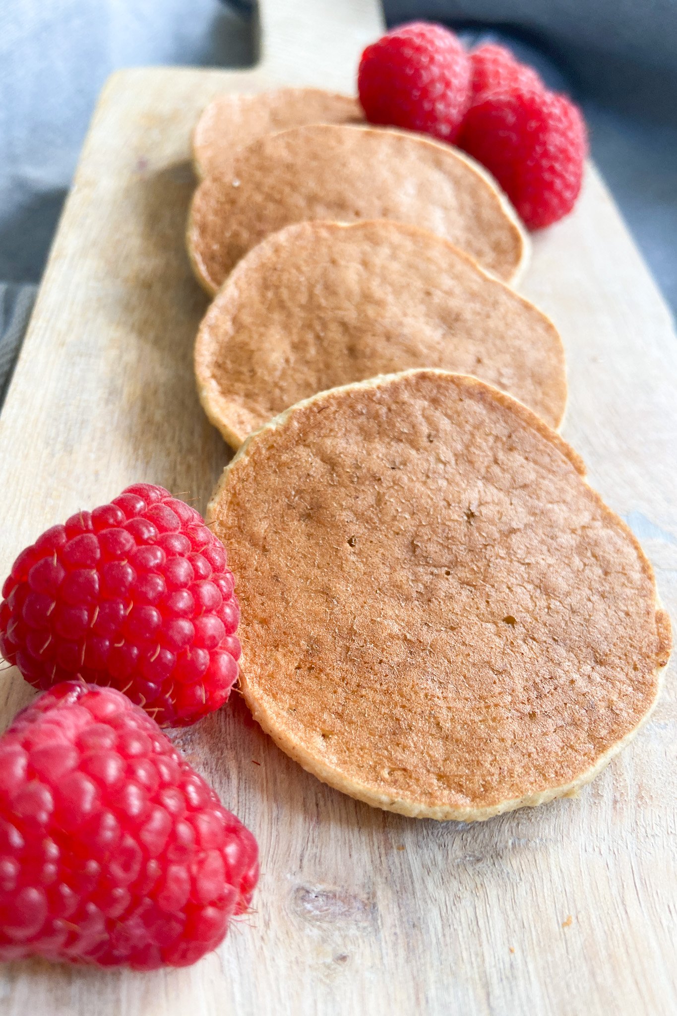 Pear pancakes served with a side of raspberries