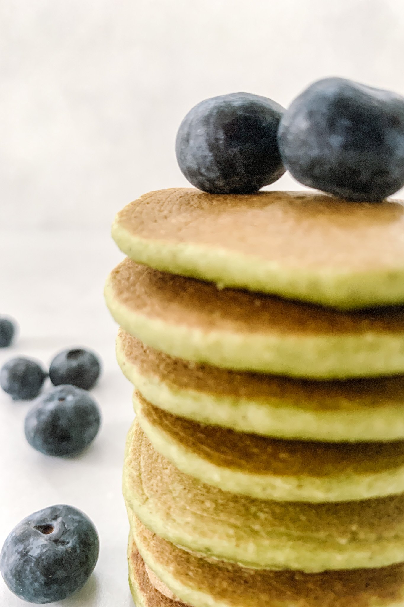 Spinach banana pancakes topped with blueberries