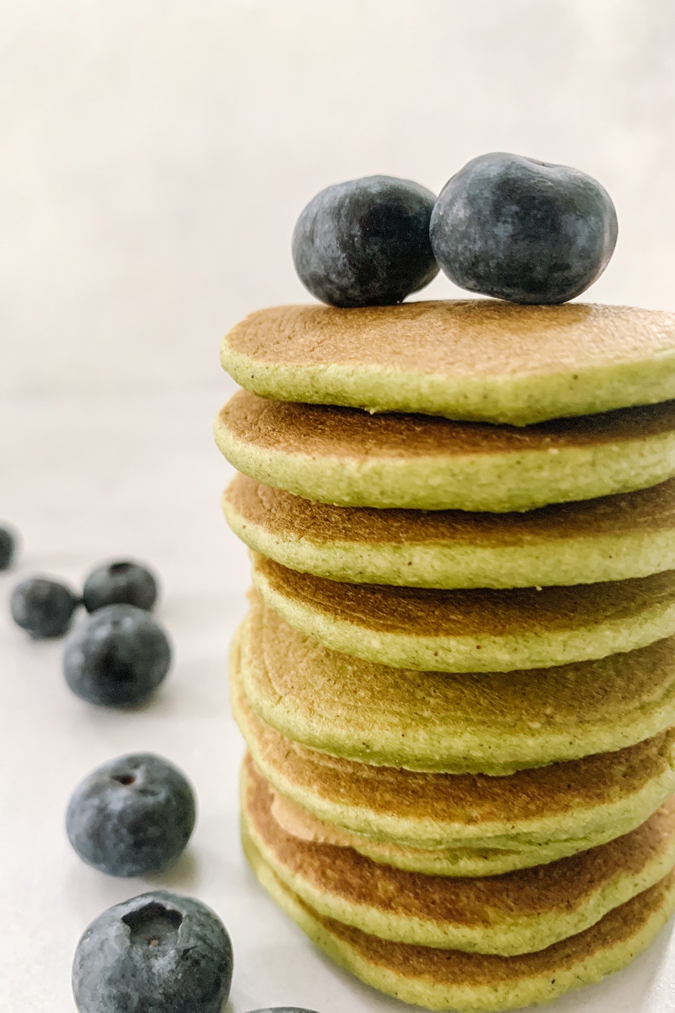 Spinach banana pancakes topped with blueberries