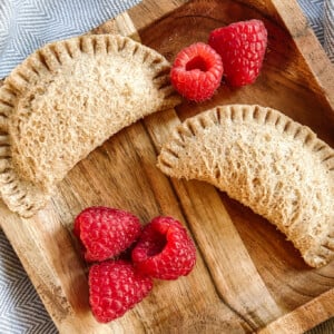 Peanut butter and empanada sandwiches. Served with a side of raspberries.
