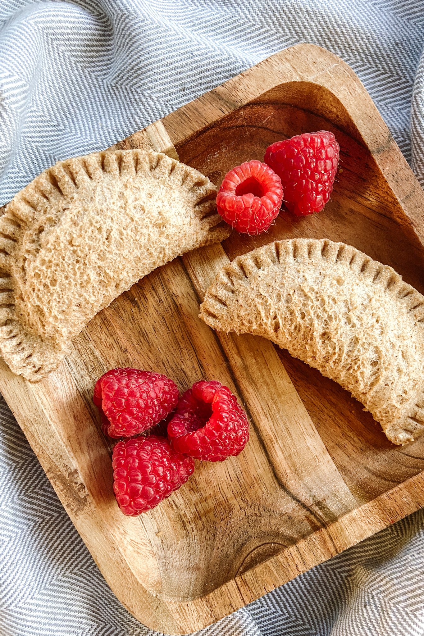 Peanut butter and empanada sandwiches. Served with a side of raspberries.
