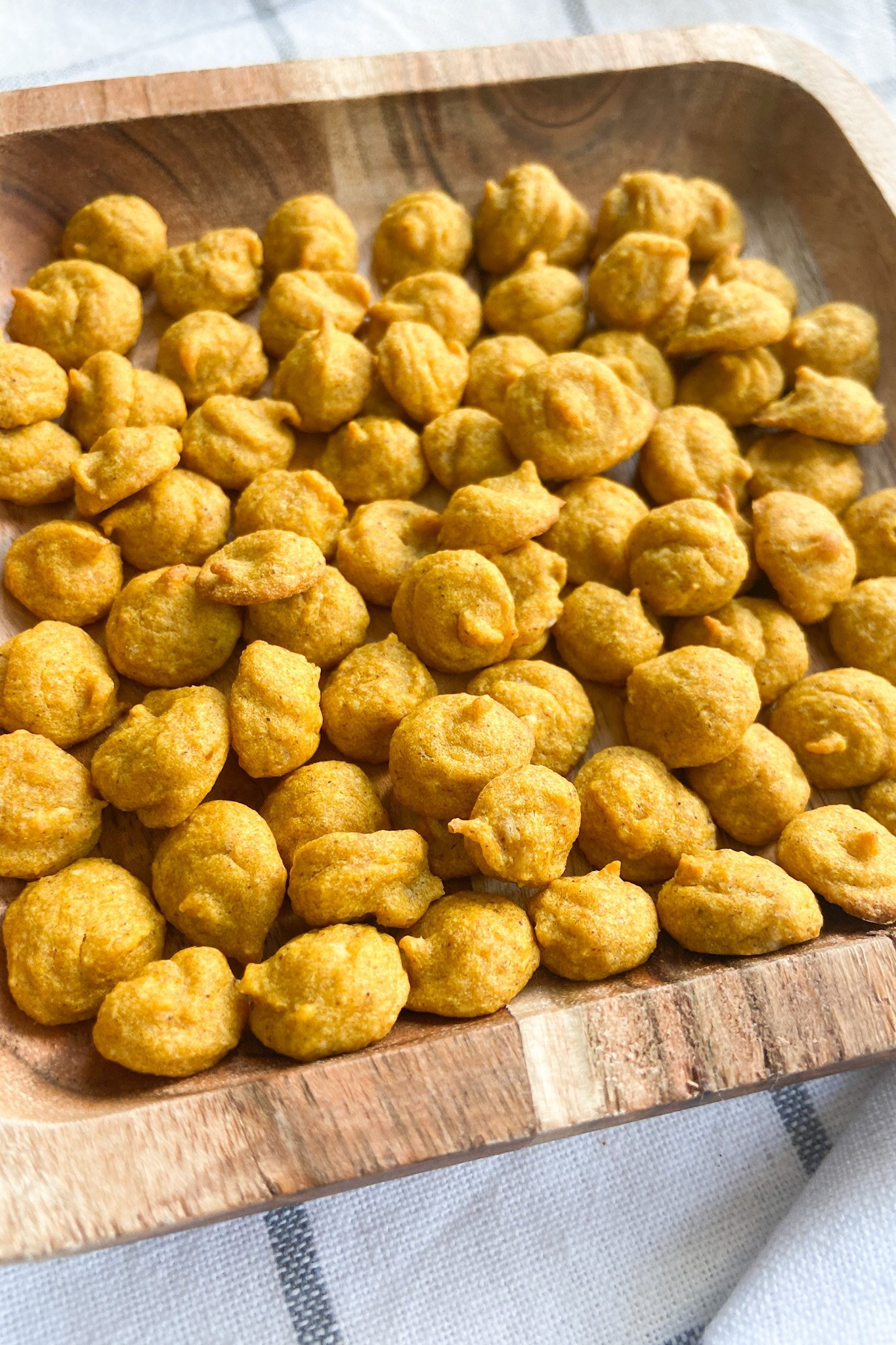 Pumpkin puffs served on a wooden plate