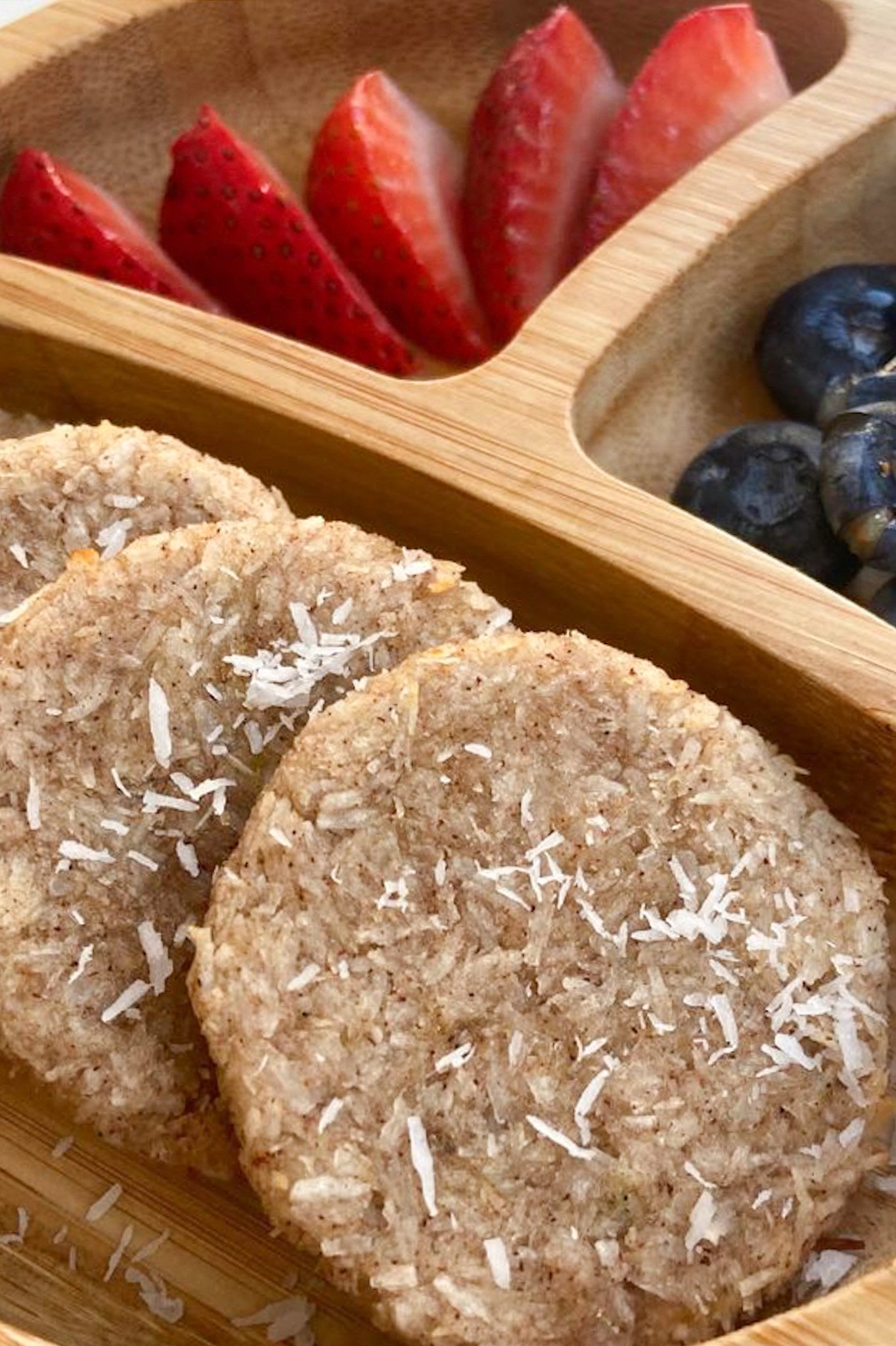 Coconut cookies served with strawberries and blueberries