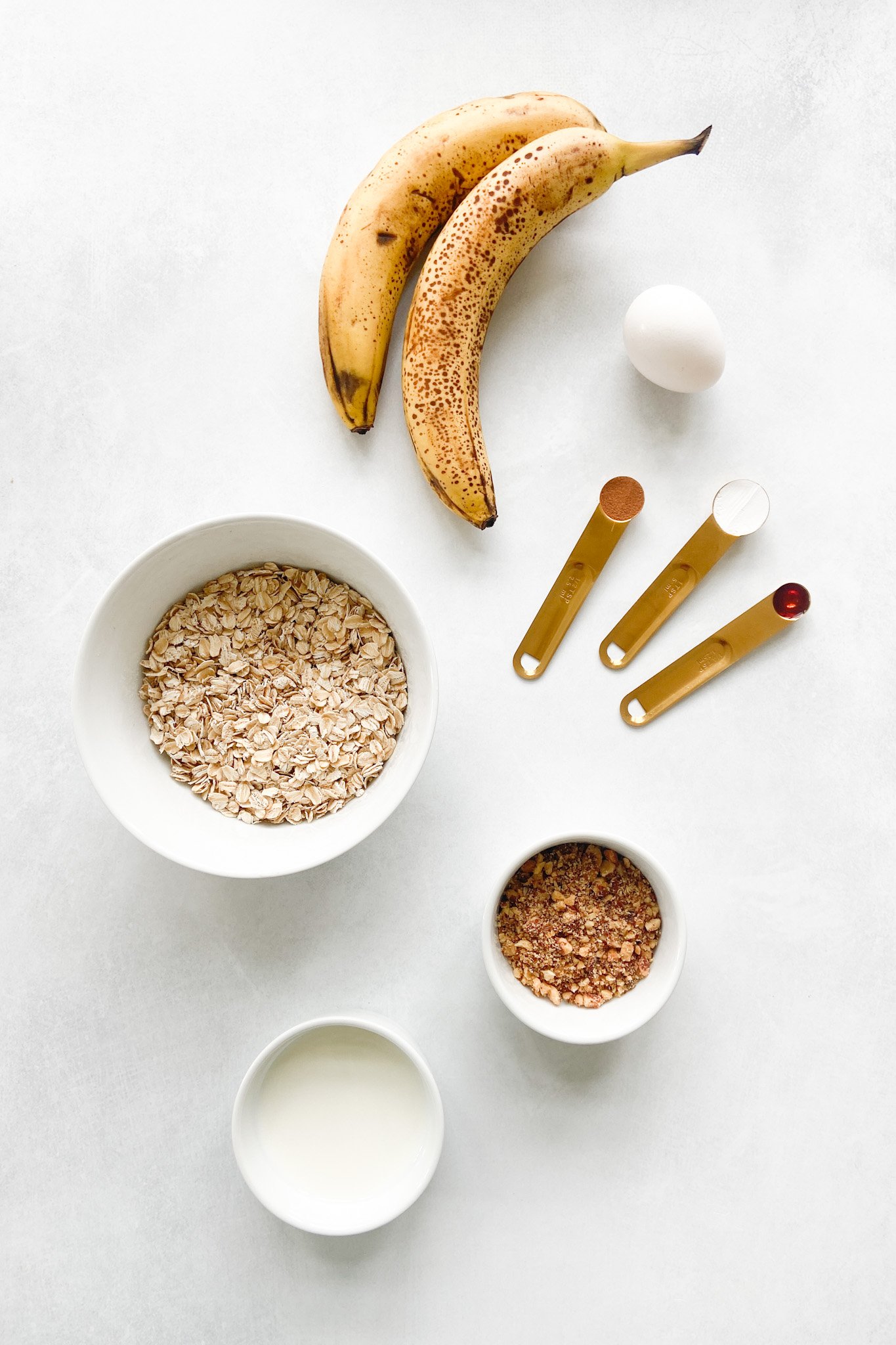 Ingredients to make banana nut muffins. See recipe card for detailed ingredient quantities.
