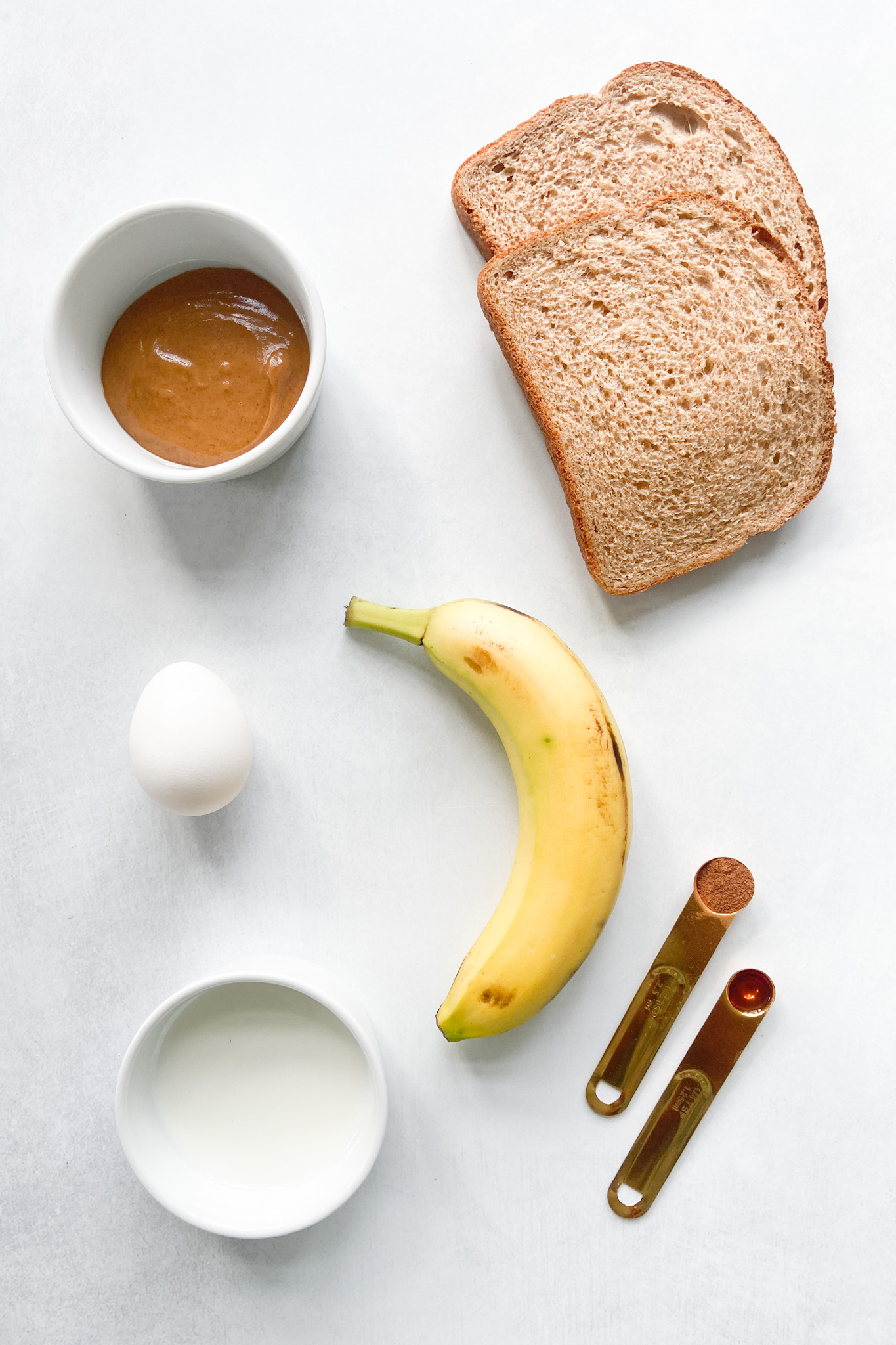 Ingredients to make peanut butter and banana French toast rollups. See recipe card for detailed ingredient quantities.