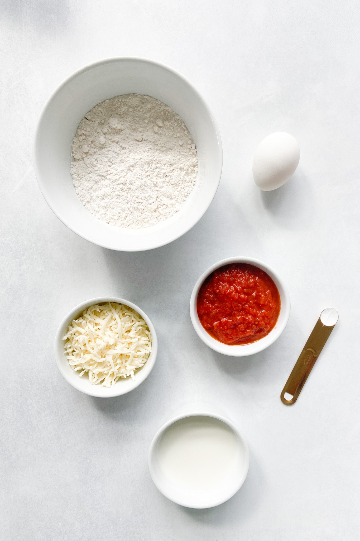 Ingredients to make pizza waffles. See recipe card for detailed ingredient quantities.