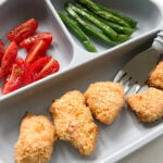 Salmon nuggets served with quartered tomatoes and green beans