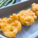 Mac and cheese bites served with green beans and strawberries