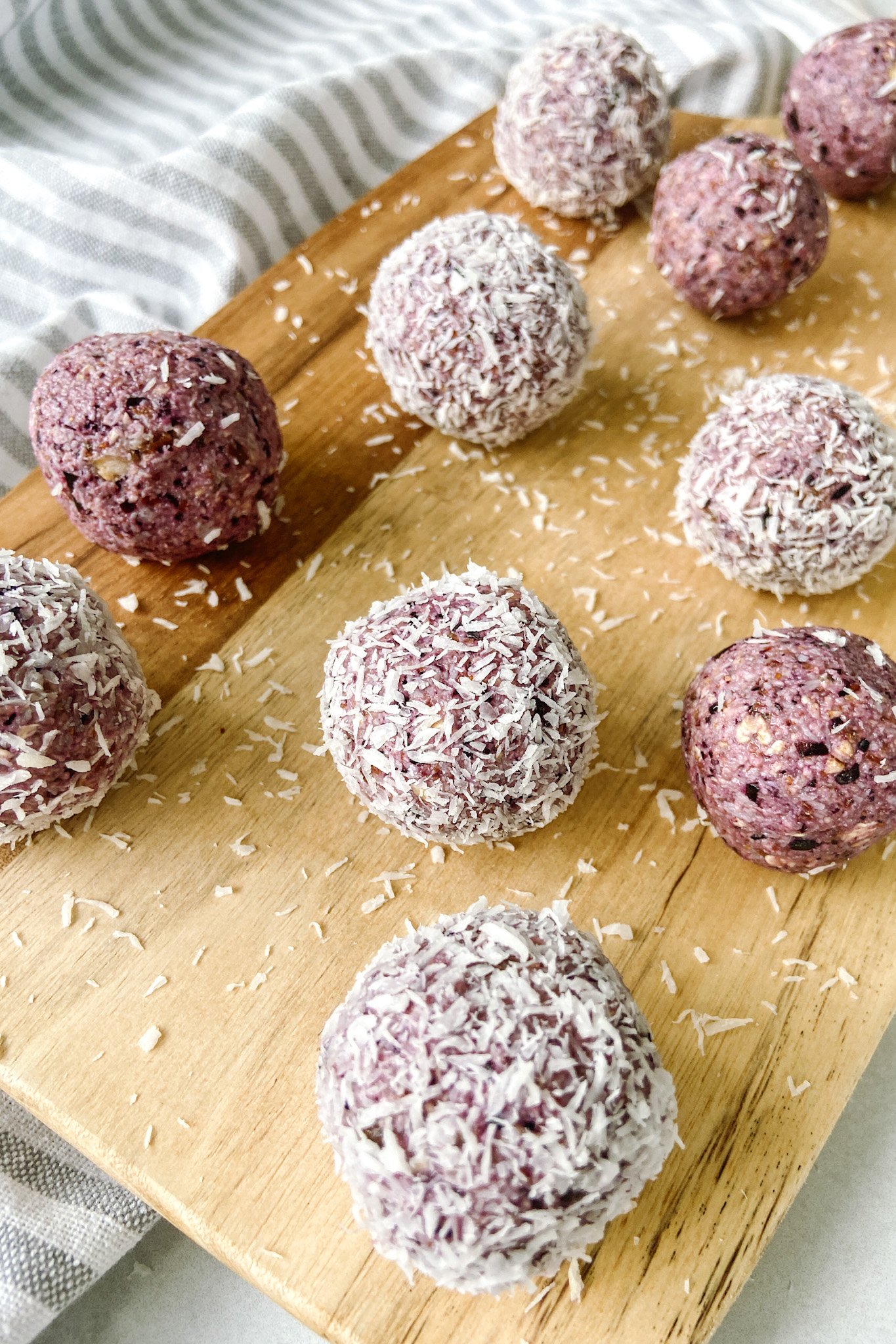 Blueberry bliss balls served on a wooden cutting board