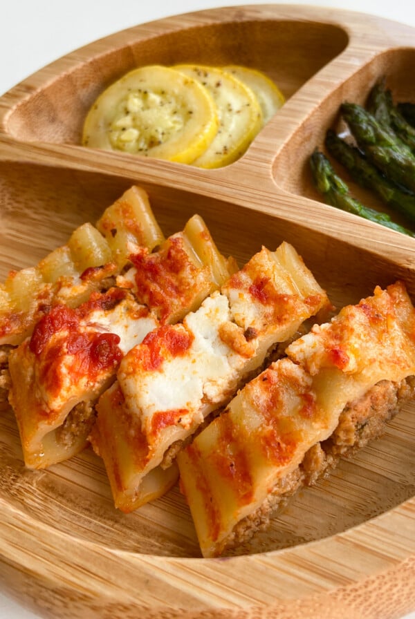 Cheesy beef manicotti sliced into pieces. Served with sliced yellow squash and asparagus.