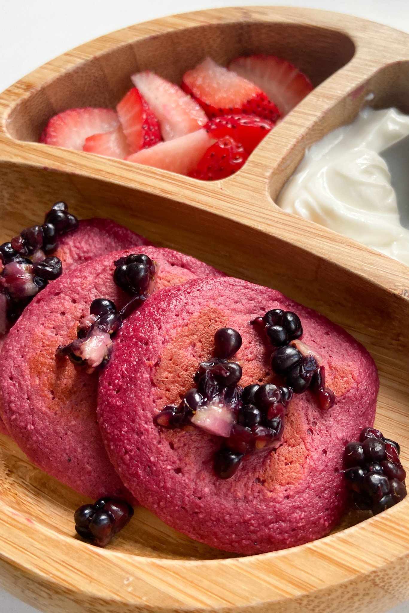 Beet banana pancakes topped with crushed blackberries