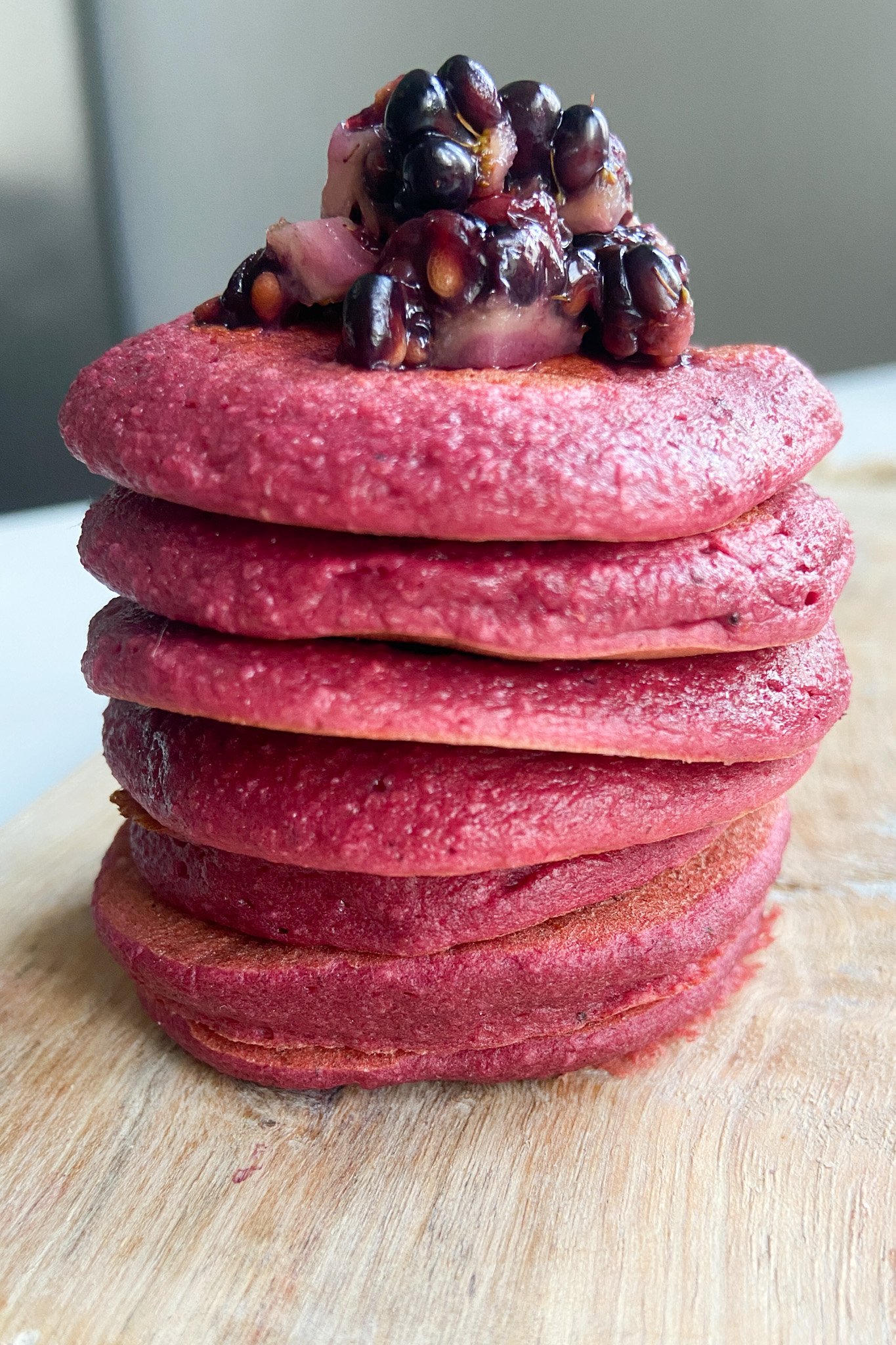 Beet banana pancakes topped with crushed blackberries