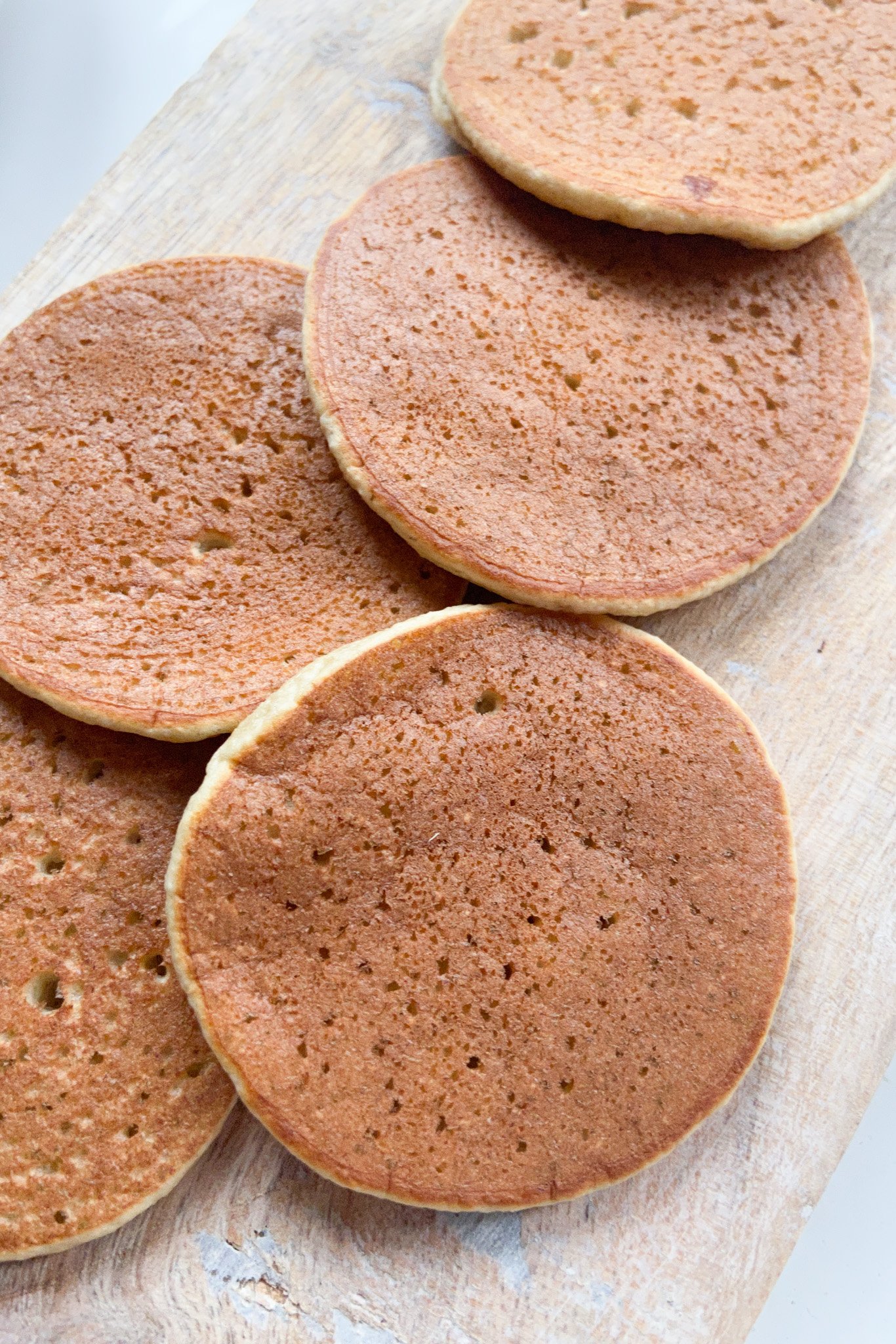 Oatmeal banana pancakes served on a wooden tray