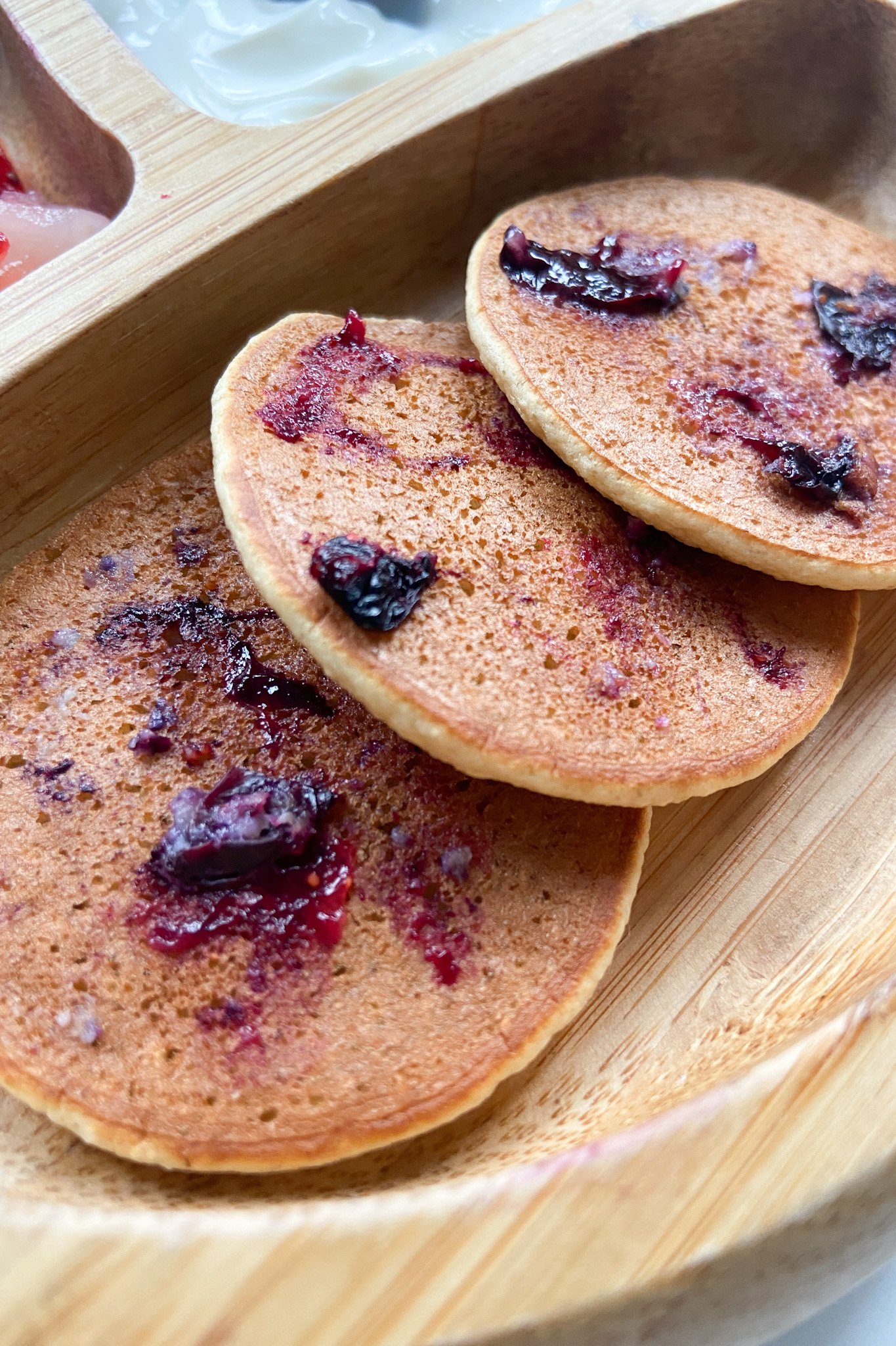 Blueberry oat pancakes served on a wooden plate