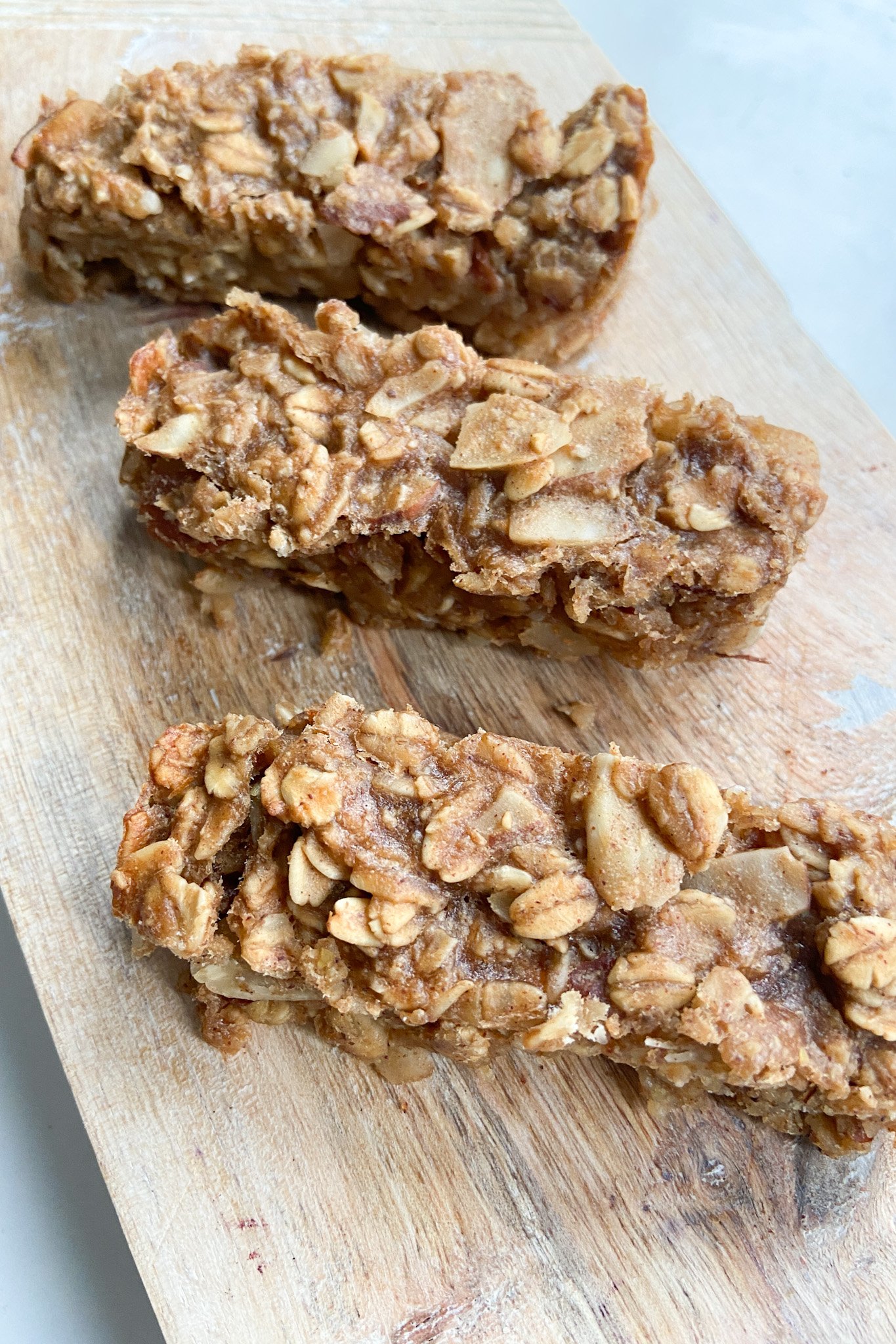 Peanut butter and banana granola bars served on a wooden cutting board