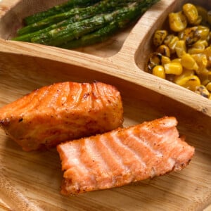 Air fryer salmon served with asparagus and roasted corn