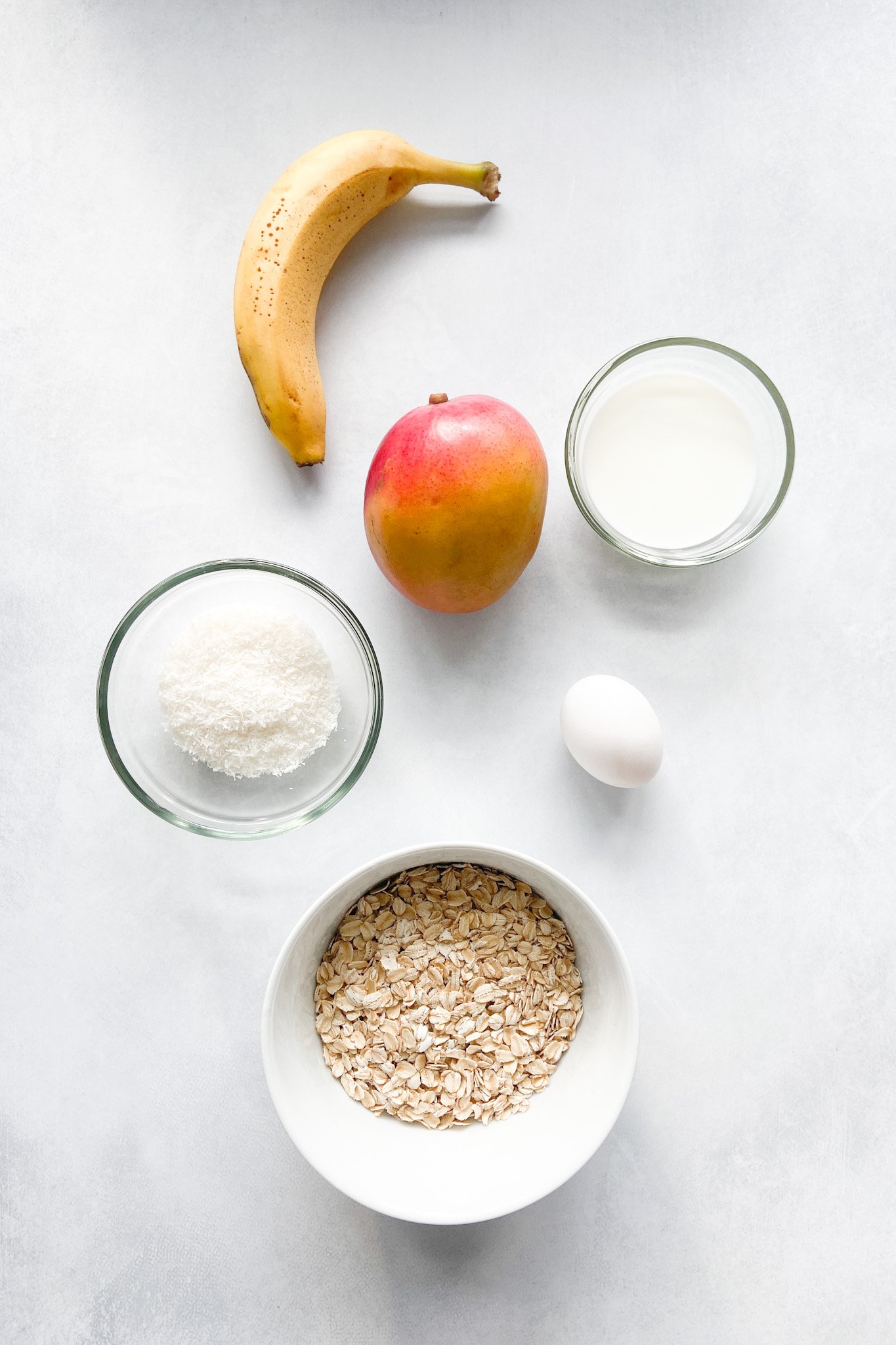 Ingredients to make mango banana oat bites. See recipe card for detailed ingredient quantities.