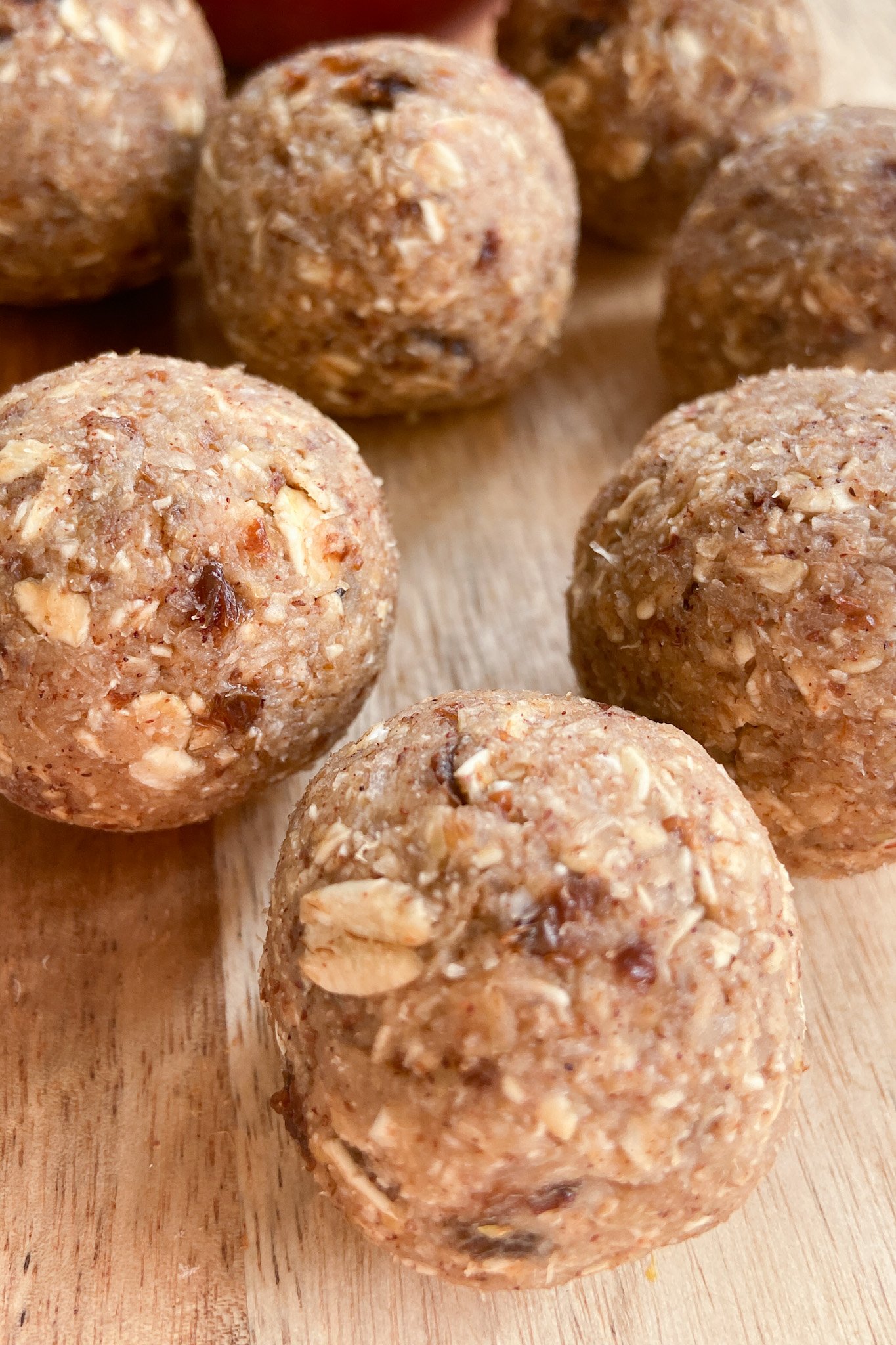 Apple pie bliss balls served on a wooden cutting board