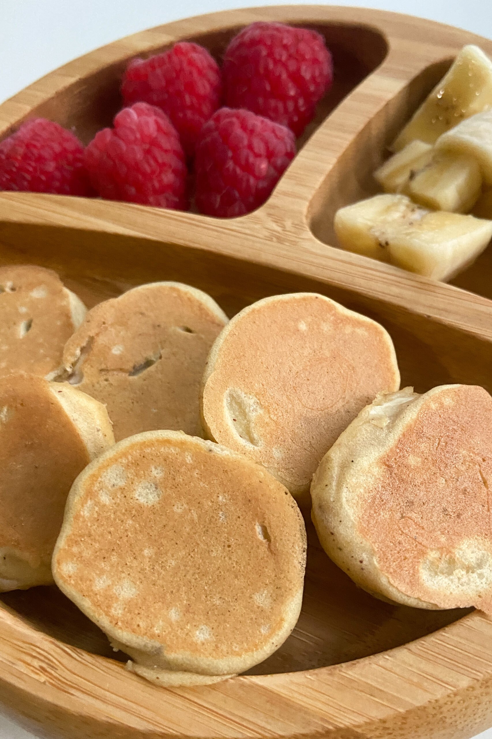 Banana pancake bites served with raspberries and sliced bananas