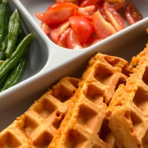 Pizza waffles served with green beans and quartered tomatoes