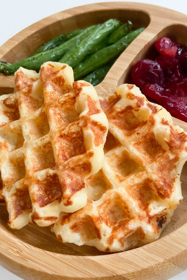 Mashed potato waffles served with green beans and mashed potatoes.