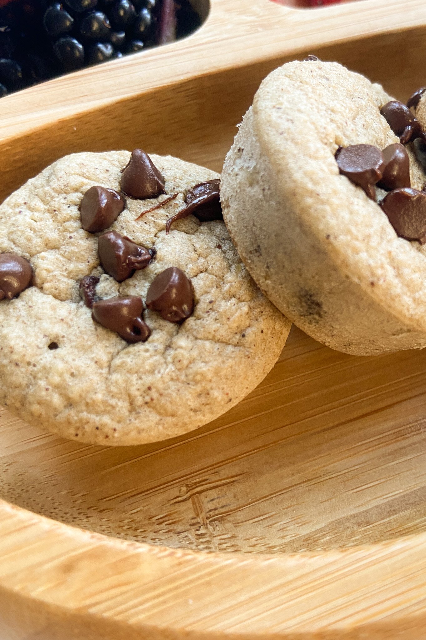 Chocolate chip oat muffins served on a wooden plate