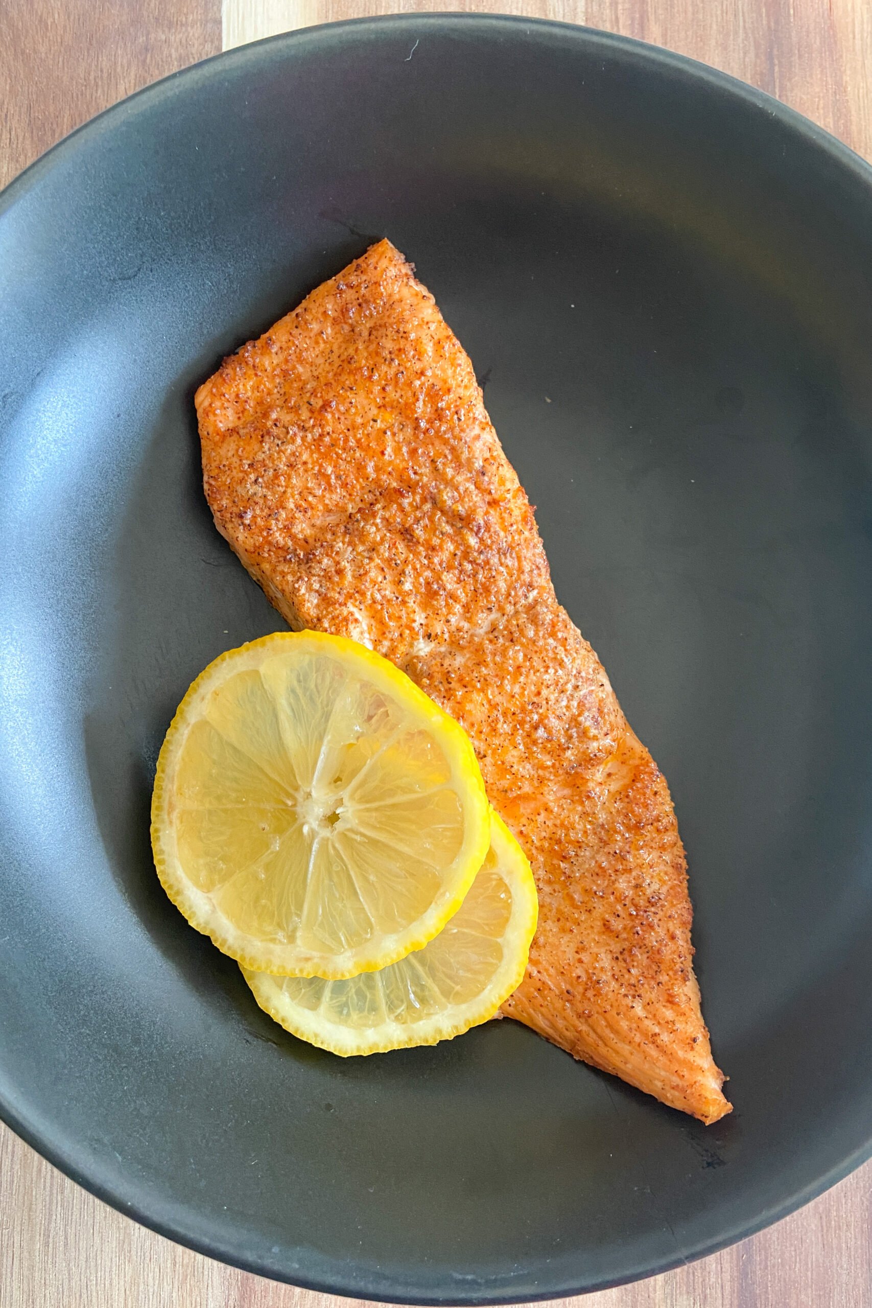 Air fryer salmon garnished with lemon slices