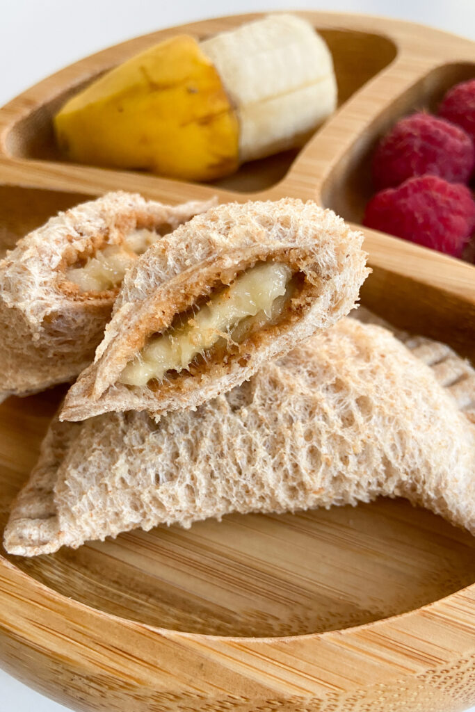 Peanut butter and banana empanada sandwiches served with banana and raspberries