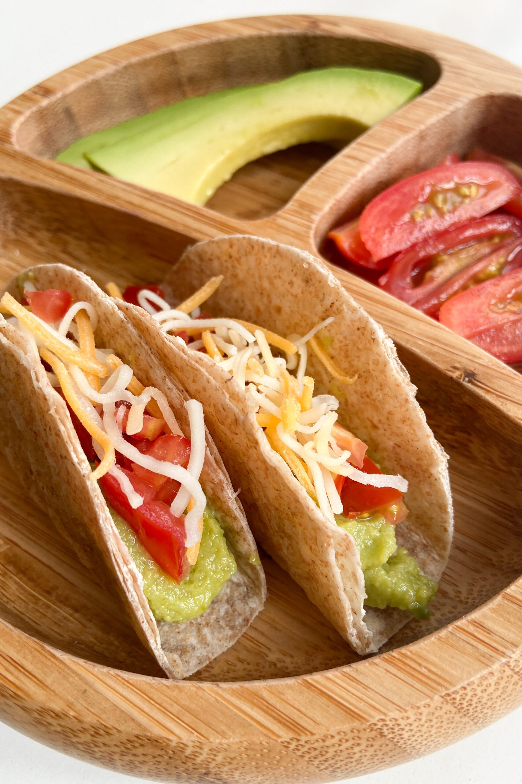 No cook taco served with avocado slices and quartered tomatoes