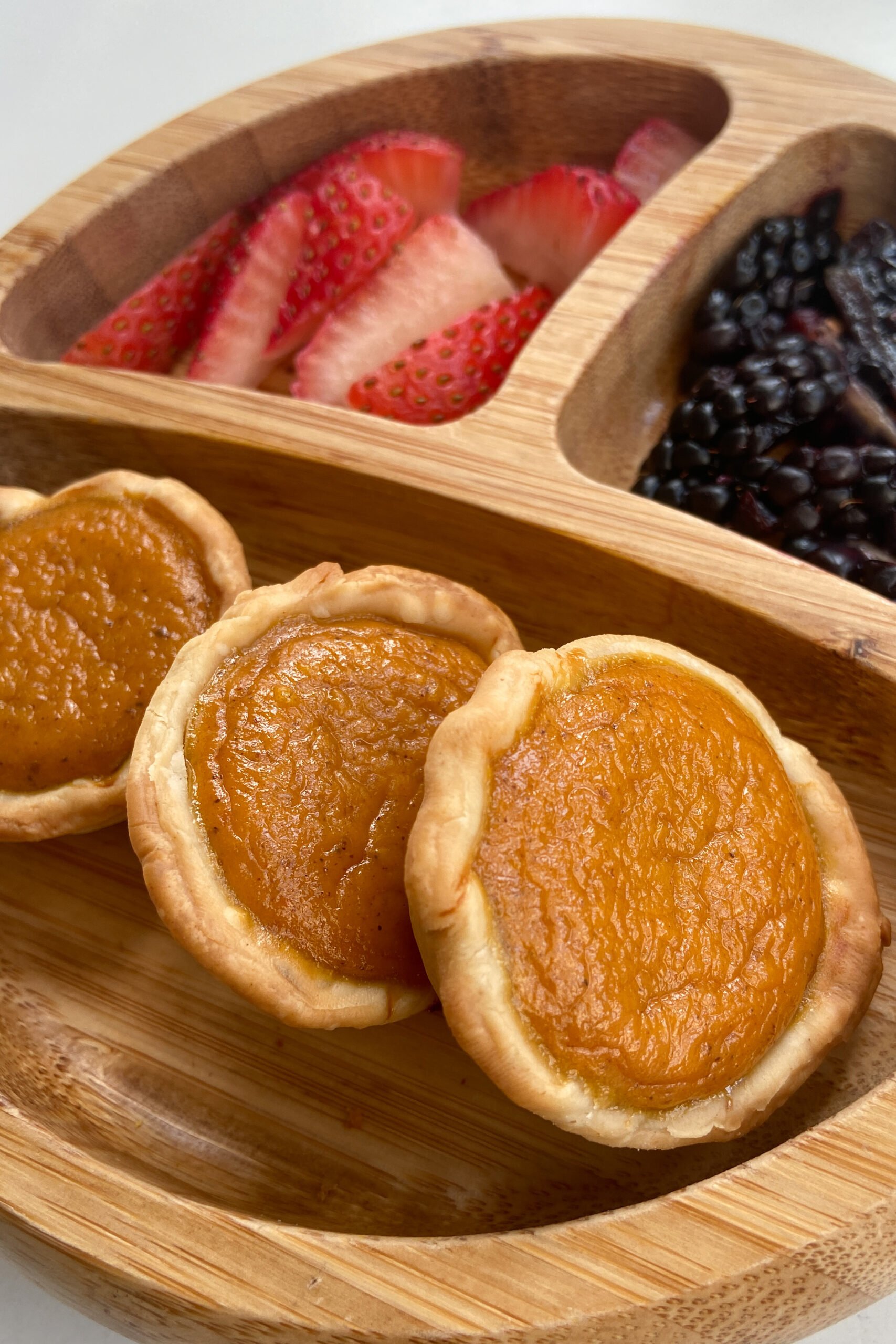 Mini pumpkin pies served with strawberries and blackberries