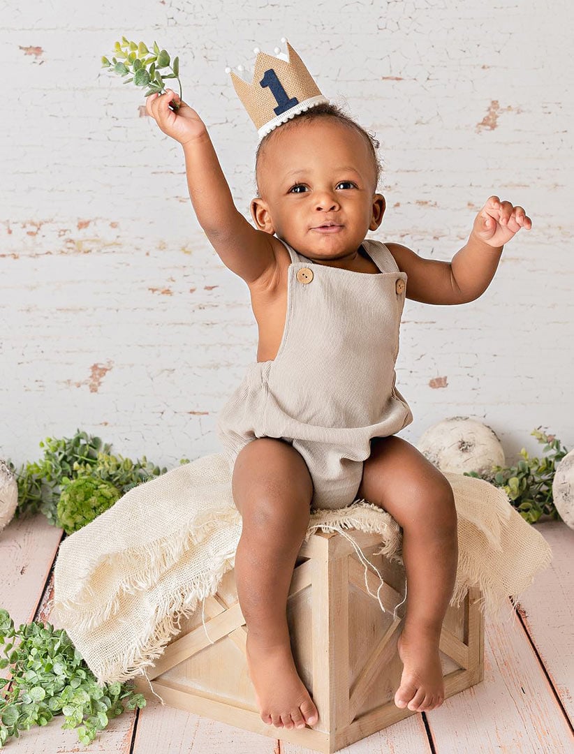 Cute little boy sitting on a wood box