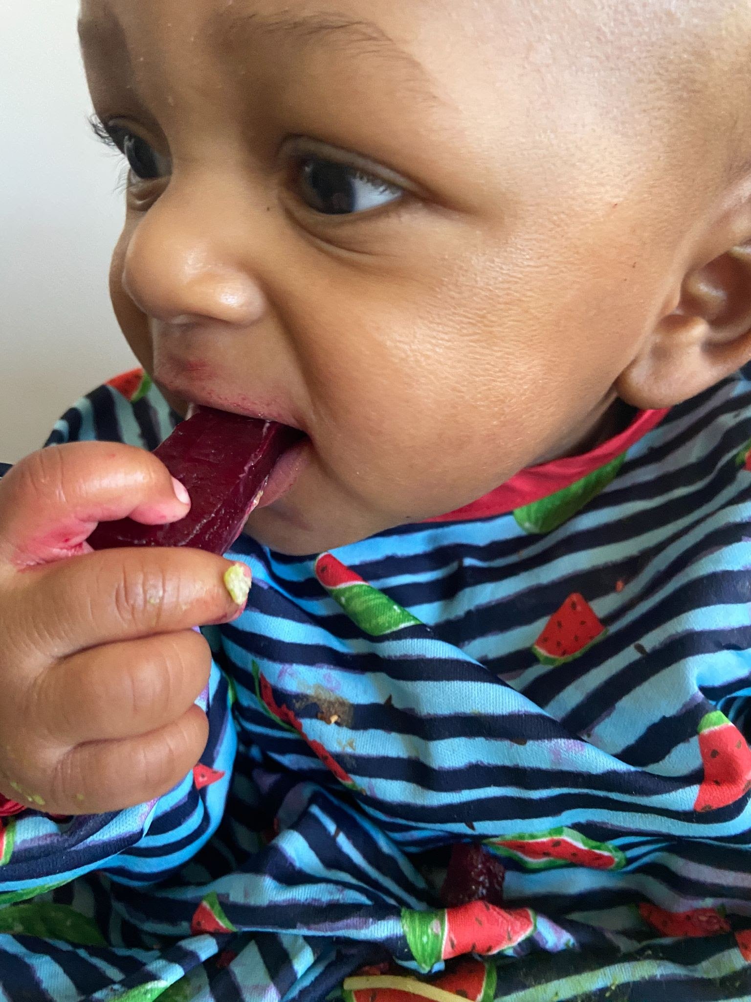 Baby-led weaning baby eating food without teeth