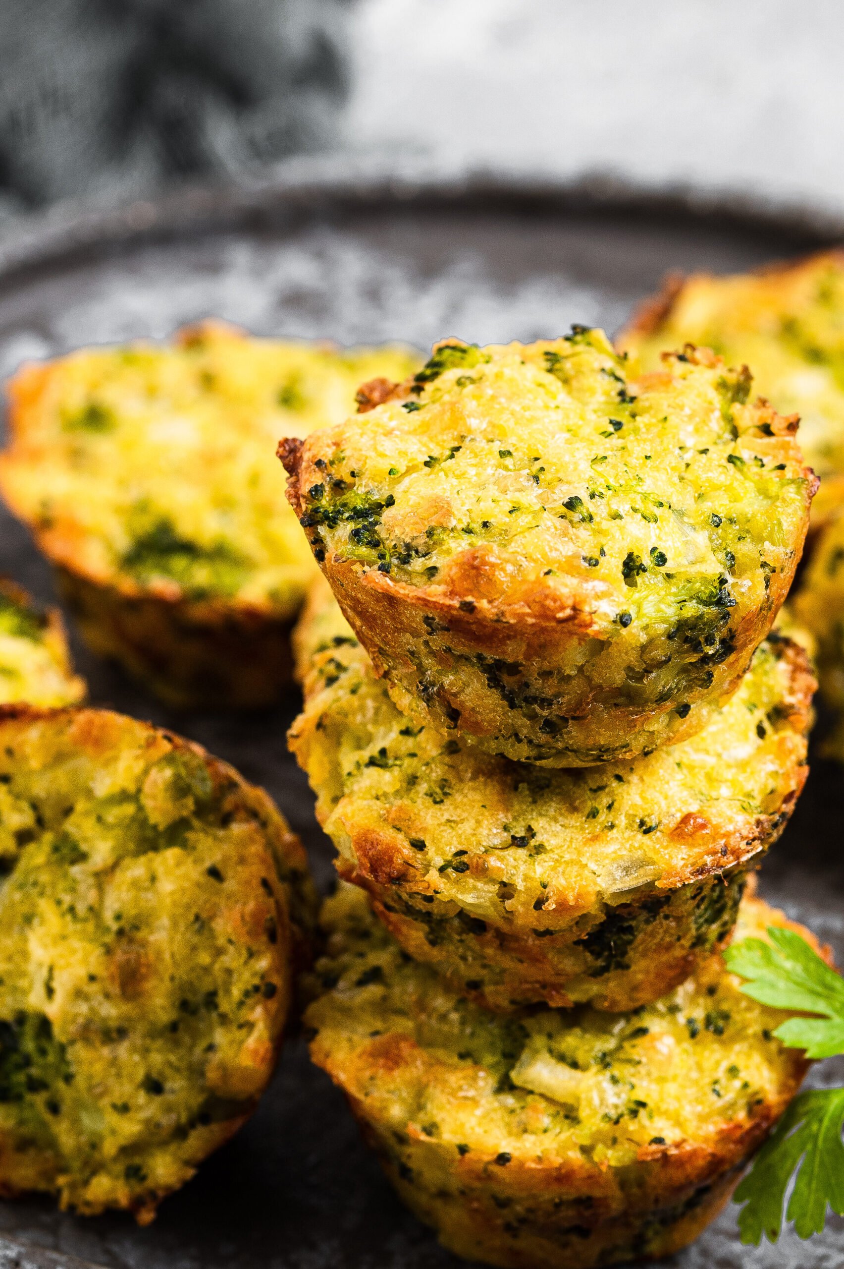 Broccoli and cheese bites served on a gray tray
