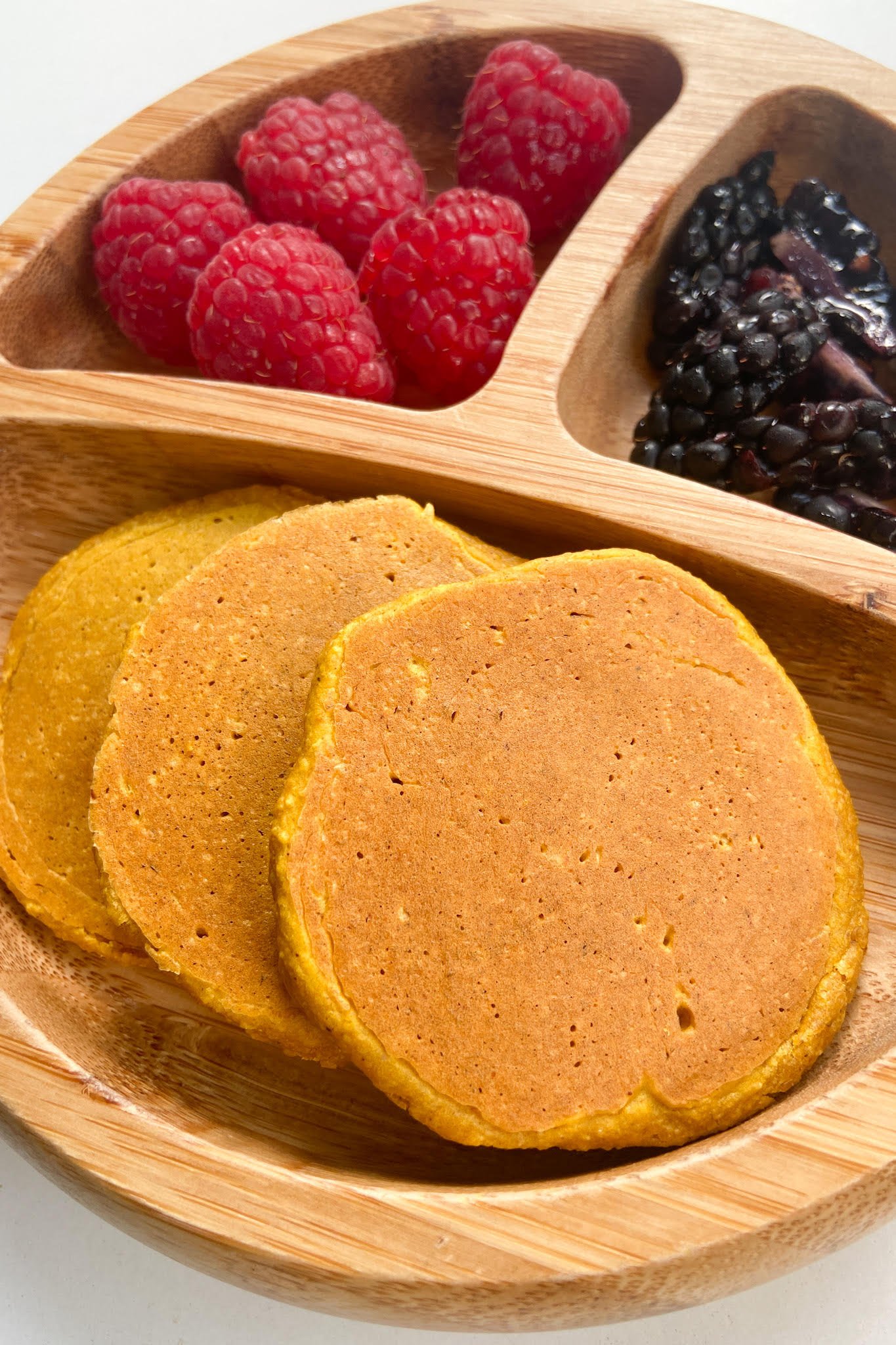 Pumpkin pancakes served with raspberries and blackberries