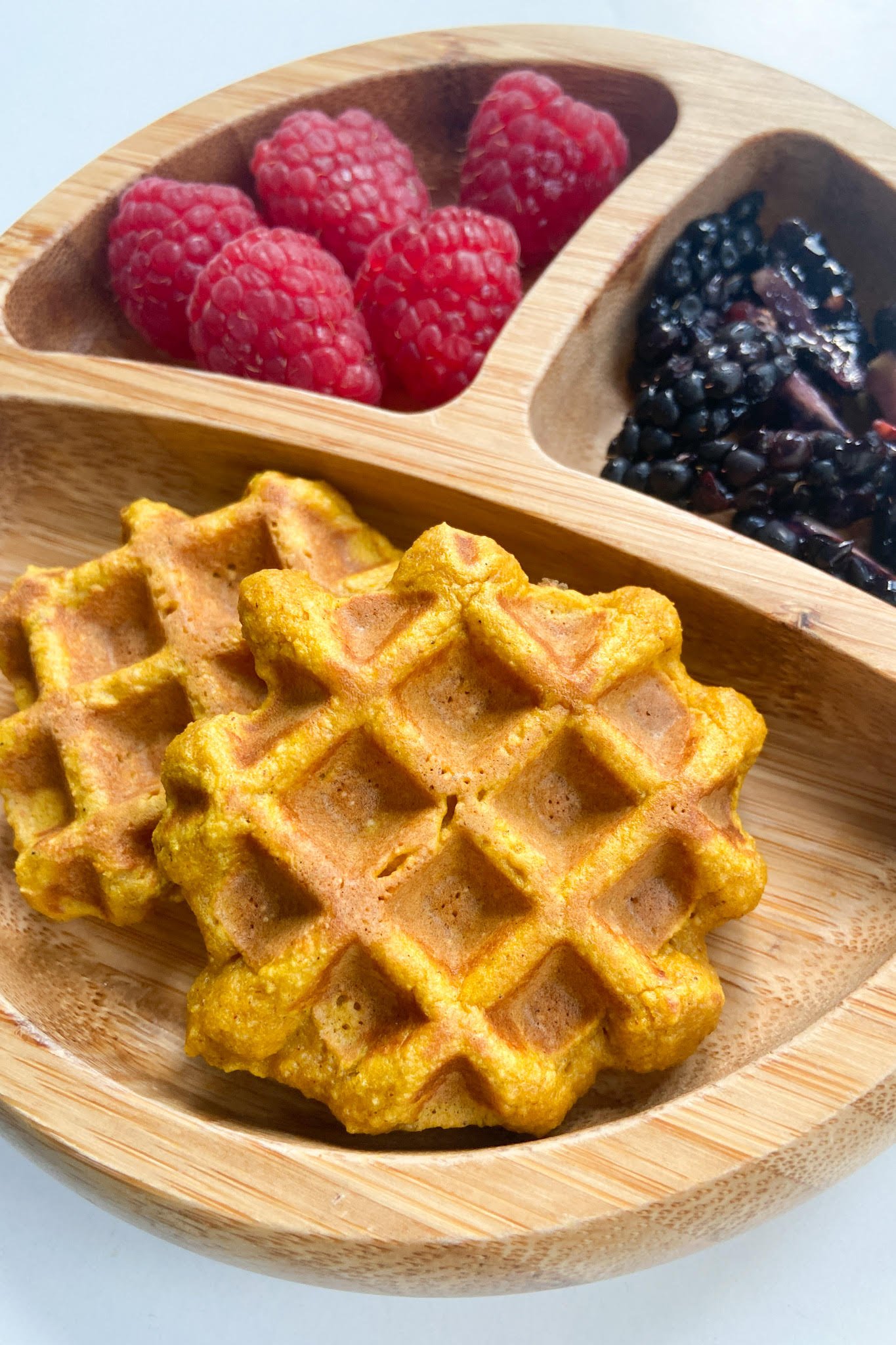 Pumpkin waffles served with raspberries and blackberries