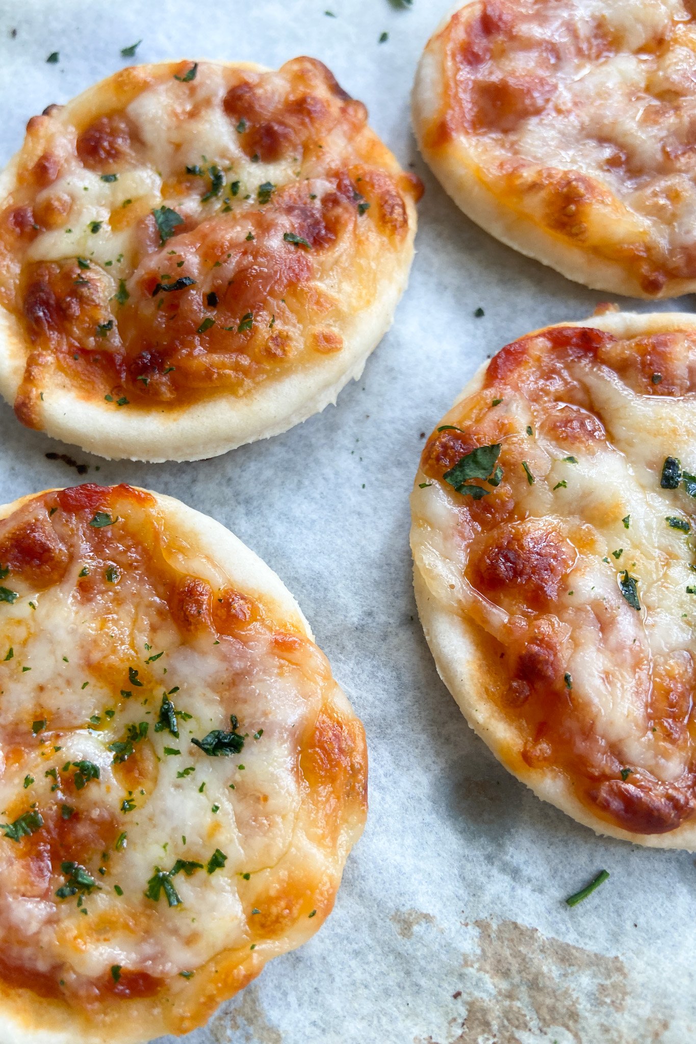 Mini pizzas press out of the oven