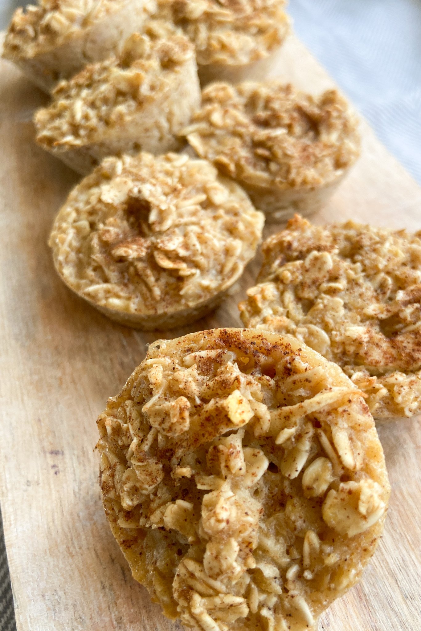 Apple oat bites served on a wooden cutting board.