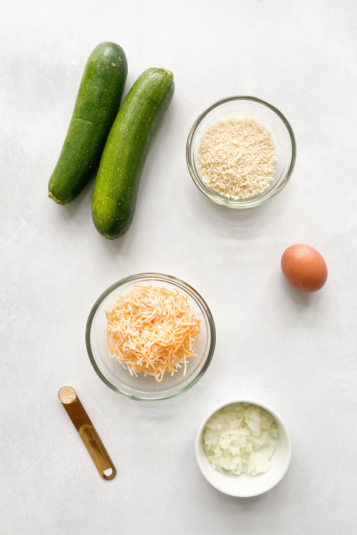 Ingredients to create cheesy zucchini fritters