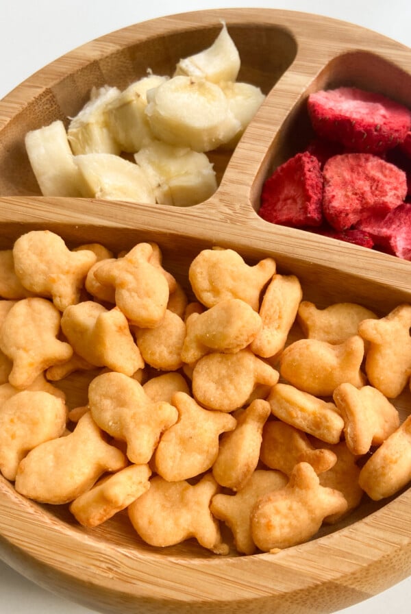 Healthy homemade goldfish crackers served with bananas and freeze dried strawberries