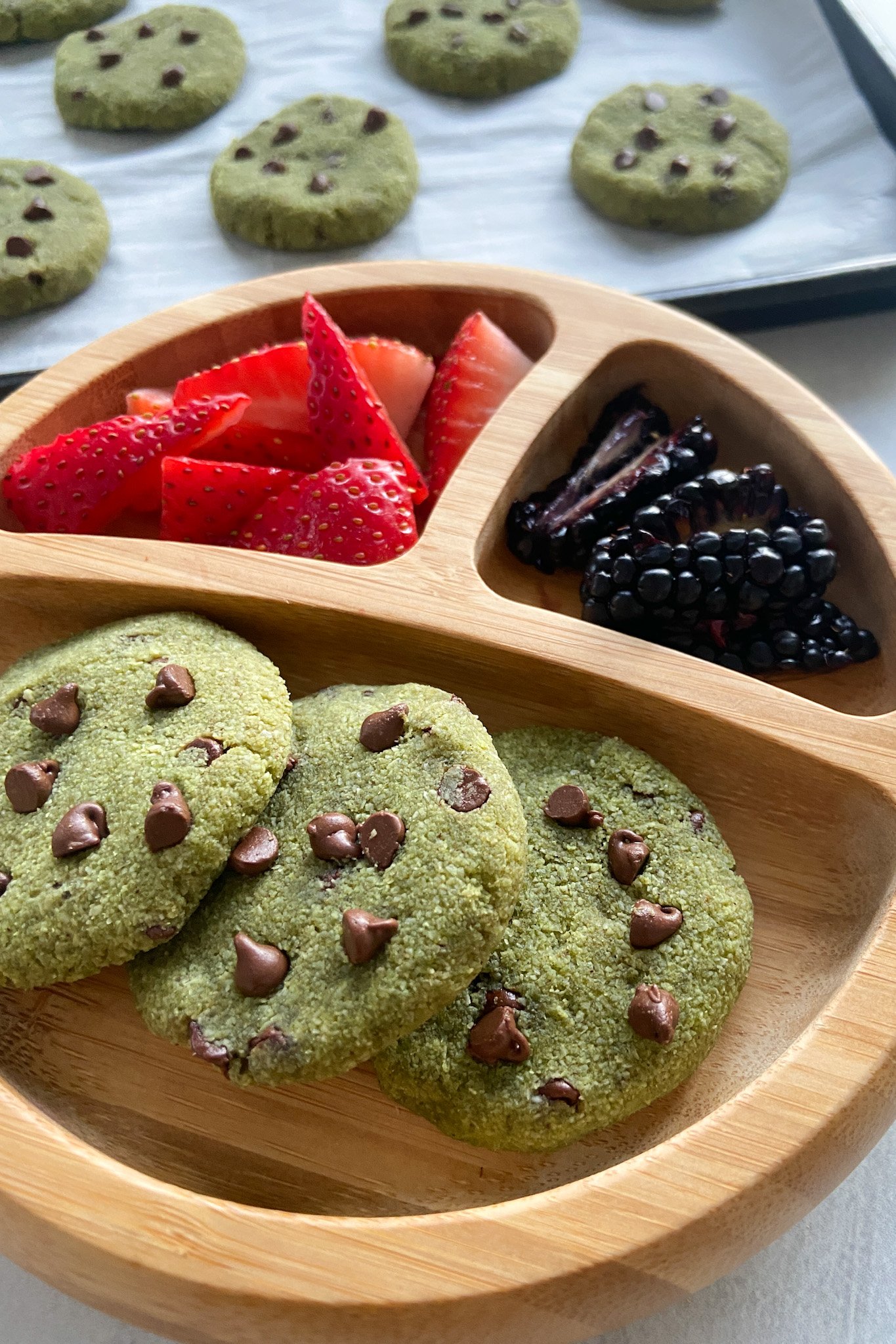 Spinach cookies served with berries