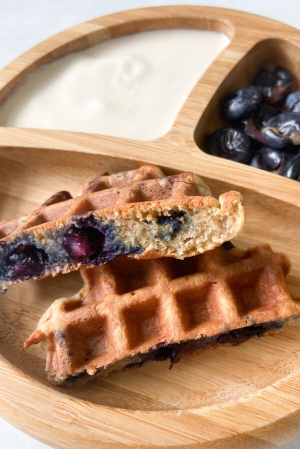 Blueberry banana waffles served with yogurt and a side of blueberries