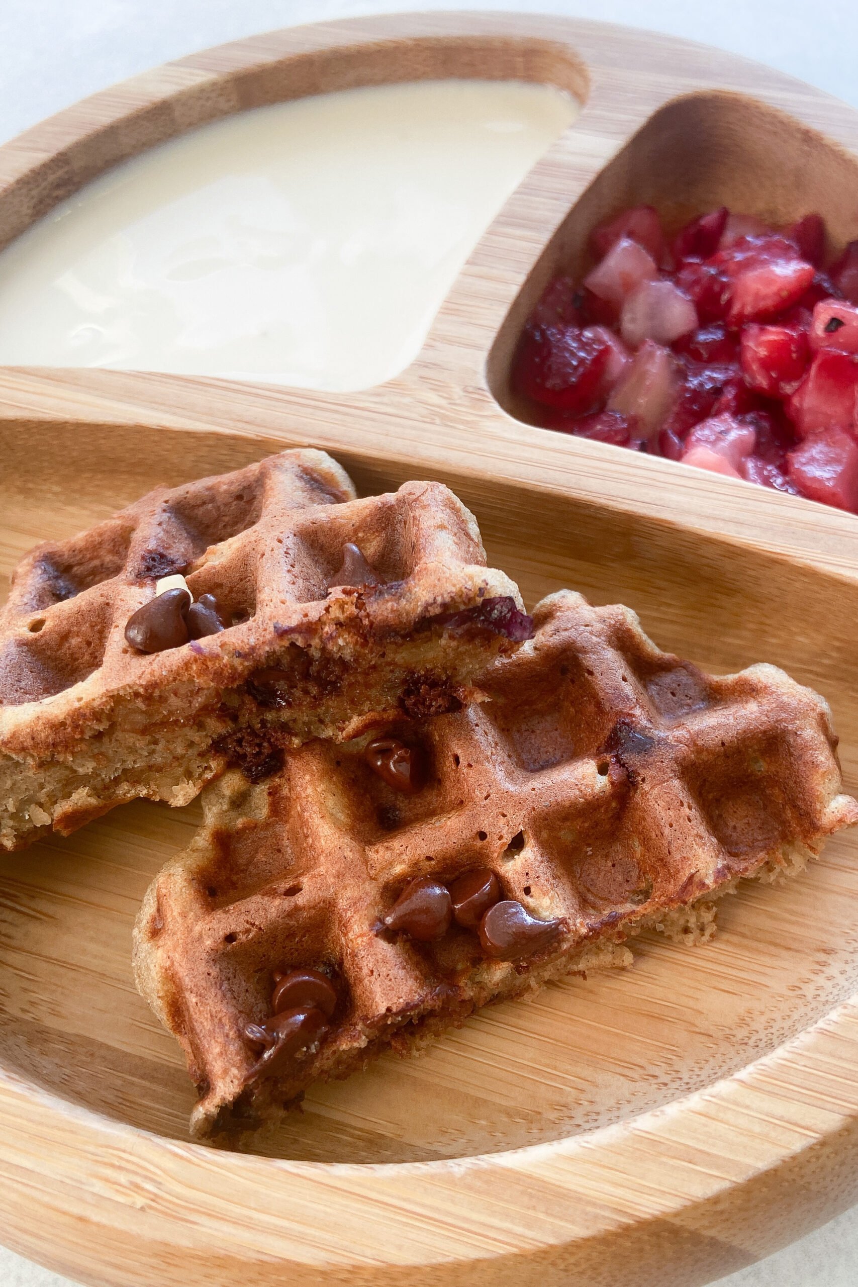 Chocolate chip banana oat waffles served with yogurt and berries